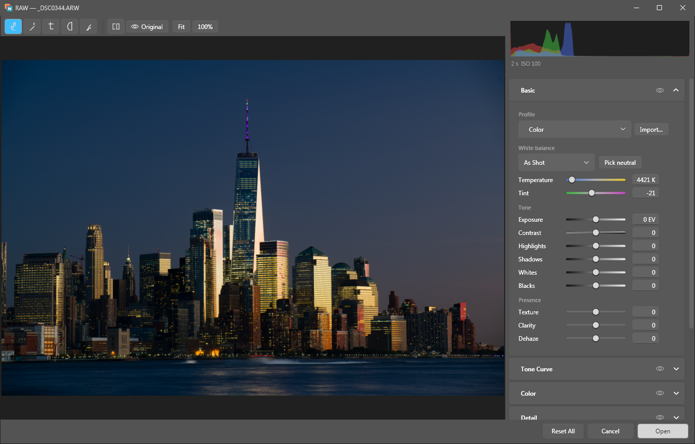 The RAW editor with the basic panel open: profile, white balance and tone sliders next to a night skyline